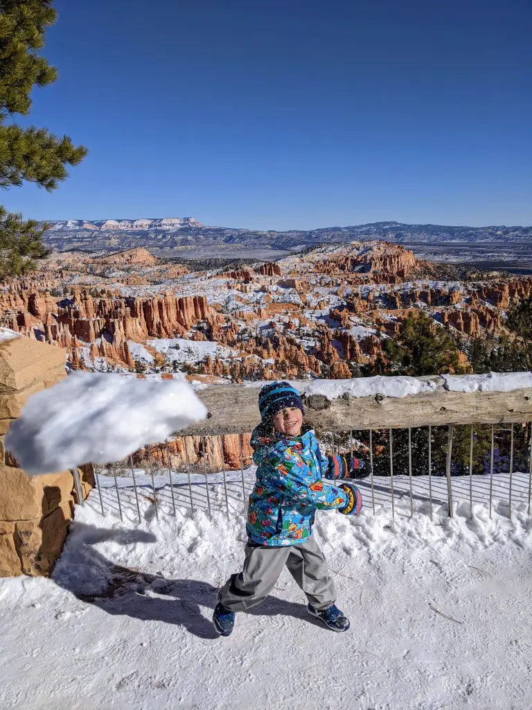 Andrew playing with snow at Sunset Point, Bryce Canyon National Park