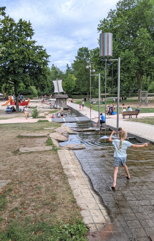 Erika happily runs into the water to cool off, Wasserspielplatz am Rhein, Kehl
