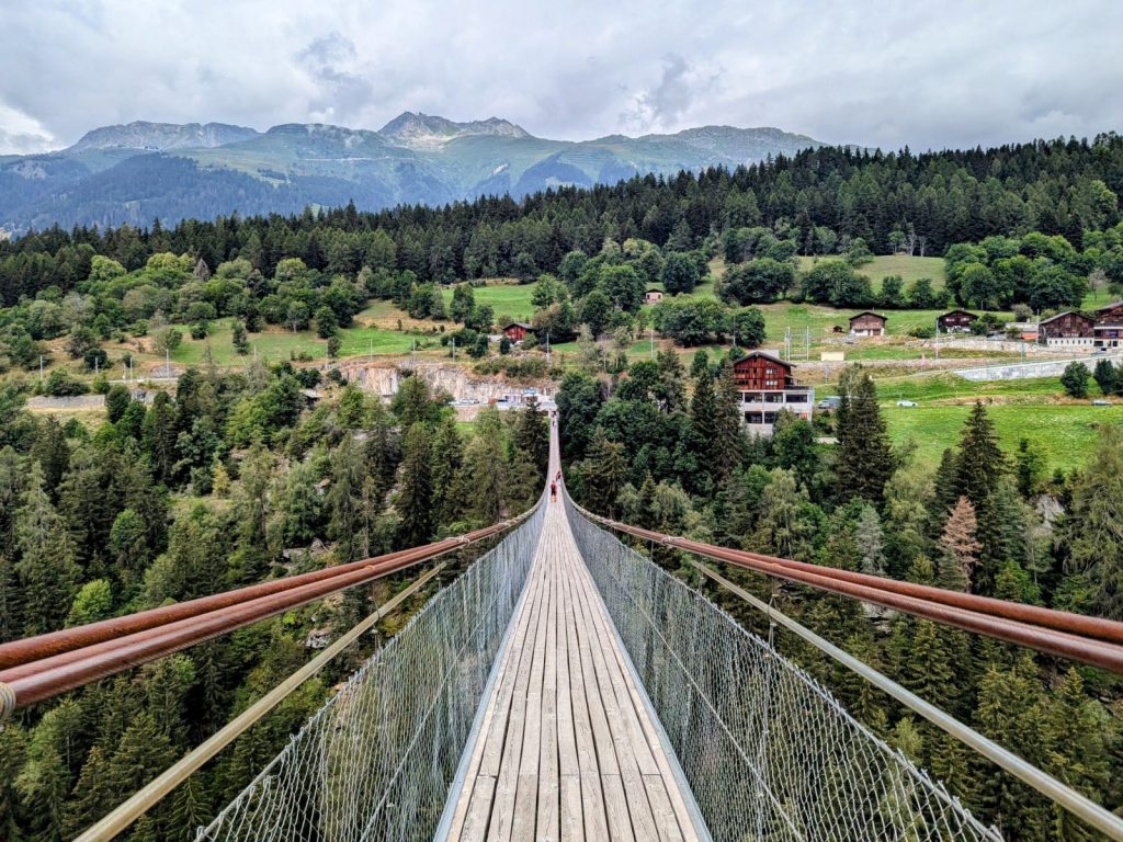 The bridge connects two charming Swiss villages—Fürgangen and Mühlebach, offering hiking, cafes, and incredible scenery