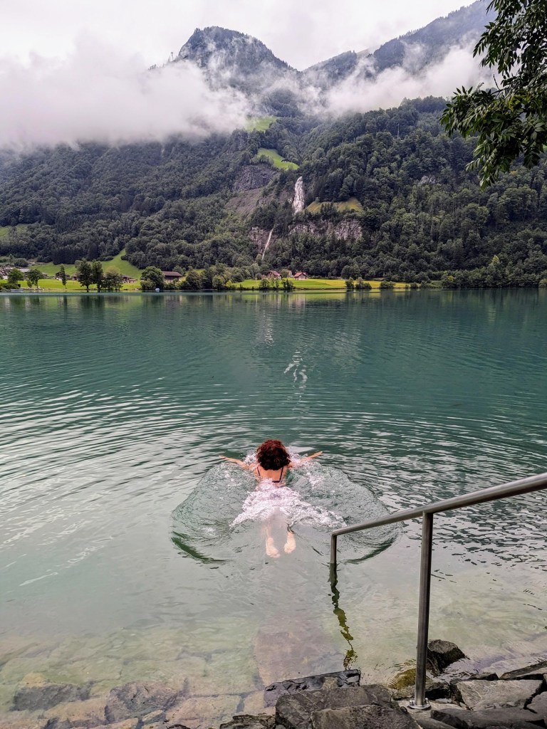 Lake Lungern on the overcast day. Waterfall looks much larger in reality than in the photo