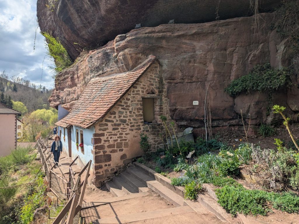 Hidden gems in France: side view of a rock house with an adjusted vegetable garden